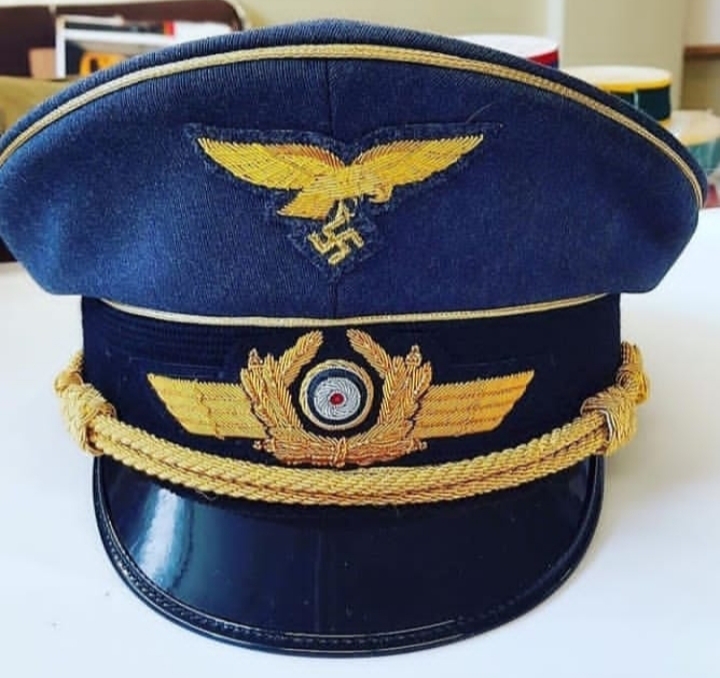WWII German Luftwaffe officer visor cap with gold embroidery, eagle insignia, and swastika.