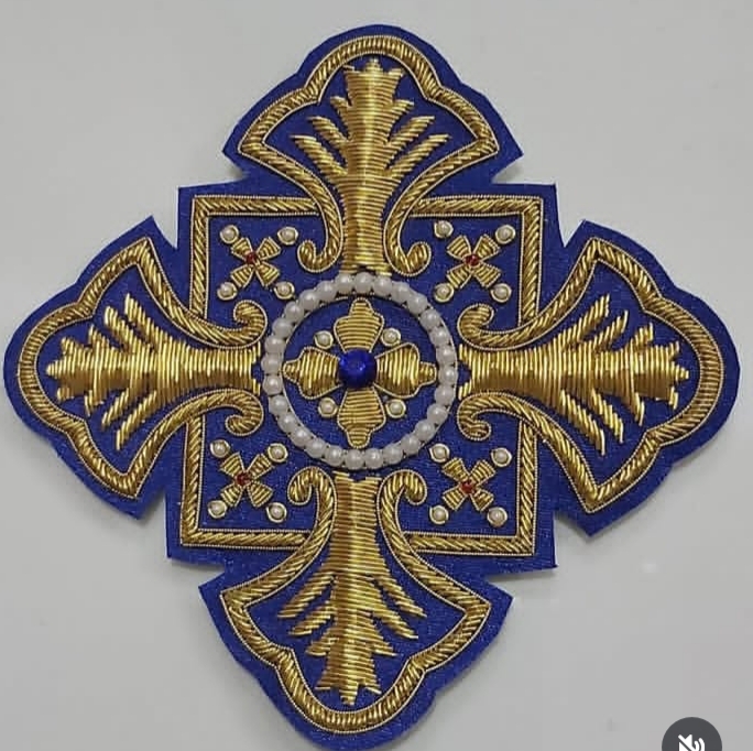 Handmade blue and gold cross embroidery patch with pearls by Yamima Sports.