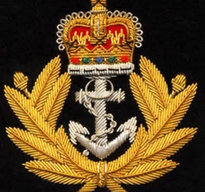 Hand-embroidered Royal Navy insignia with silver anchor, gold laurel wreath, and red-and-gold crown on black fabric.
