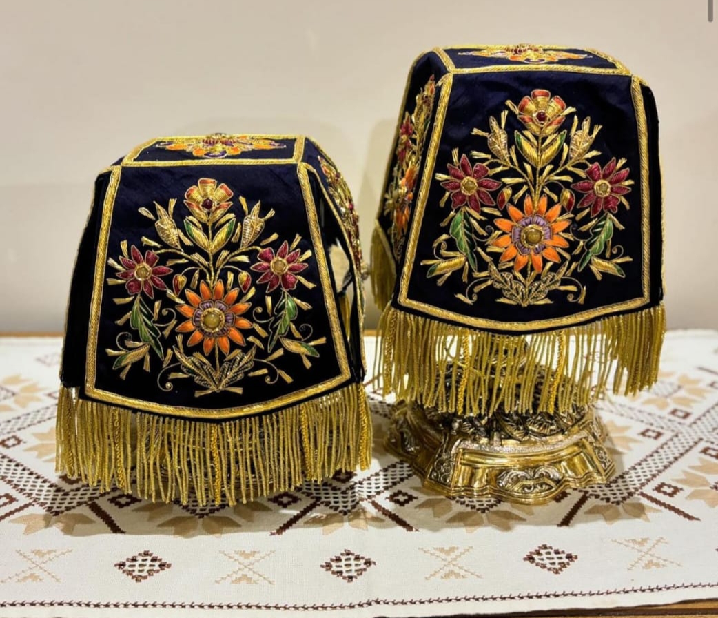 Pair of Orthodox chalice covers with intricate floral embroidery in gold, red, and orange on dark velvet fabric with gold fringe.